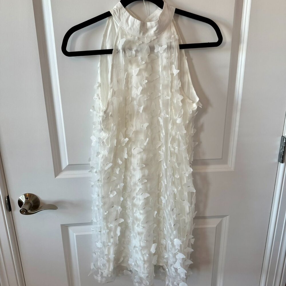 White sleeveless dress with sheer overlay, covered in 3D iridescent butterflies